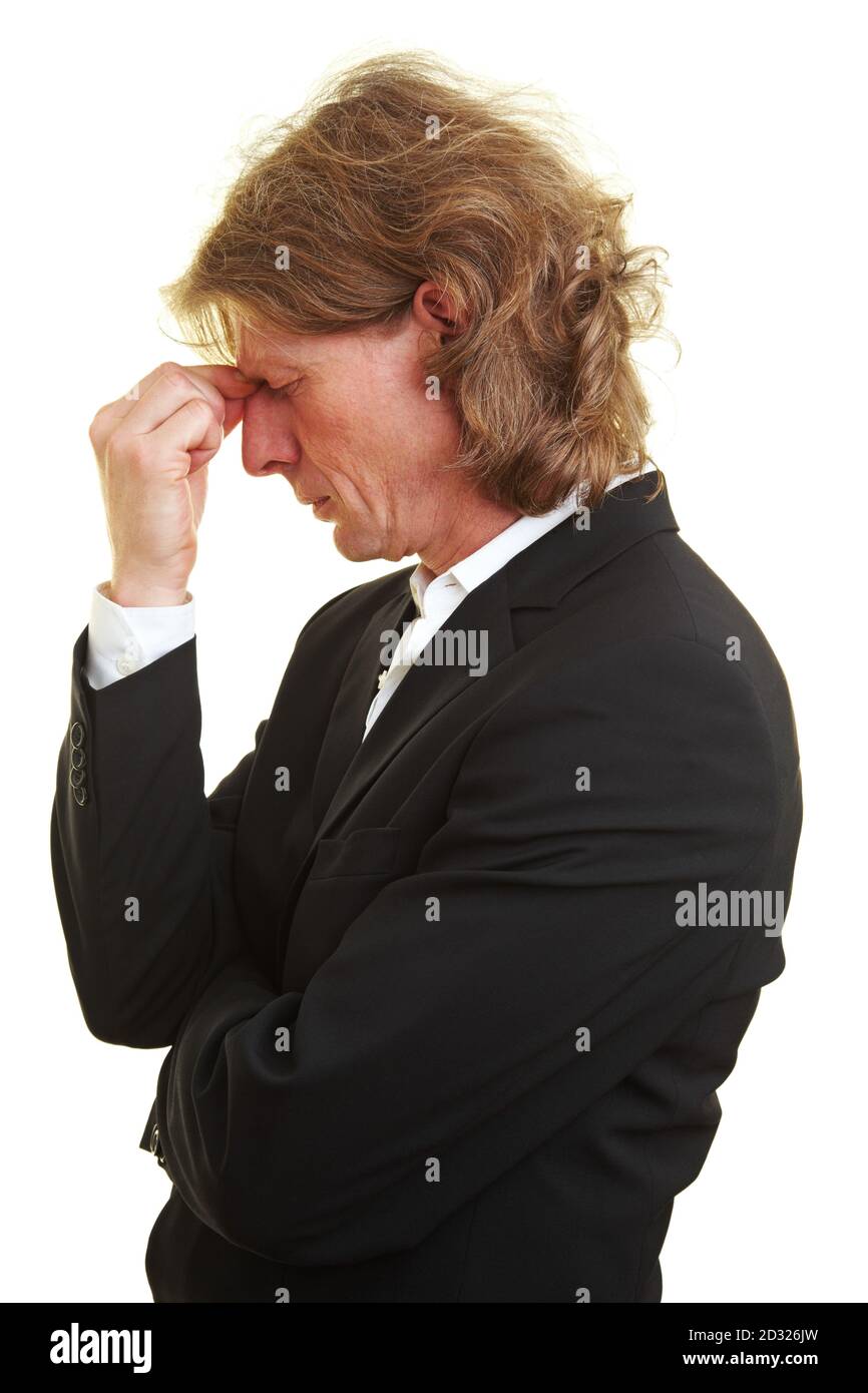 Stressed manager pinches the bridge of his nose Stock Photo Alamy