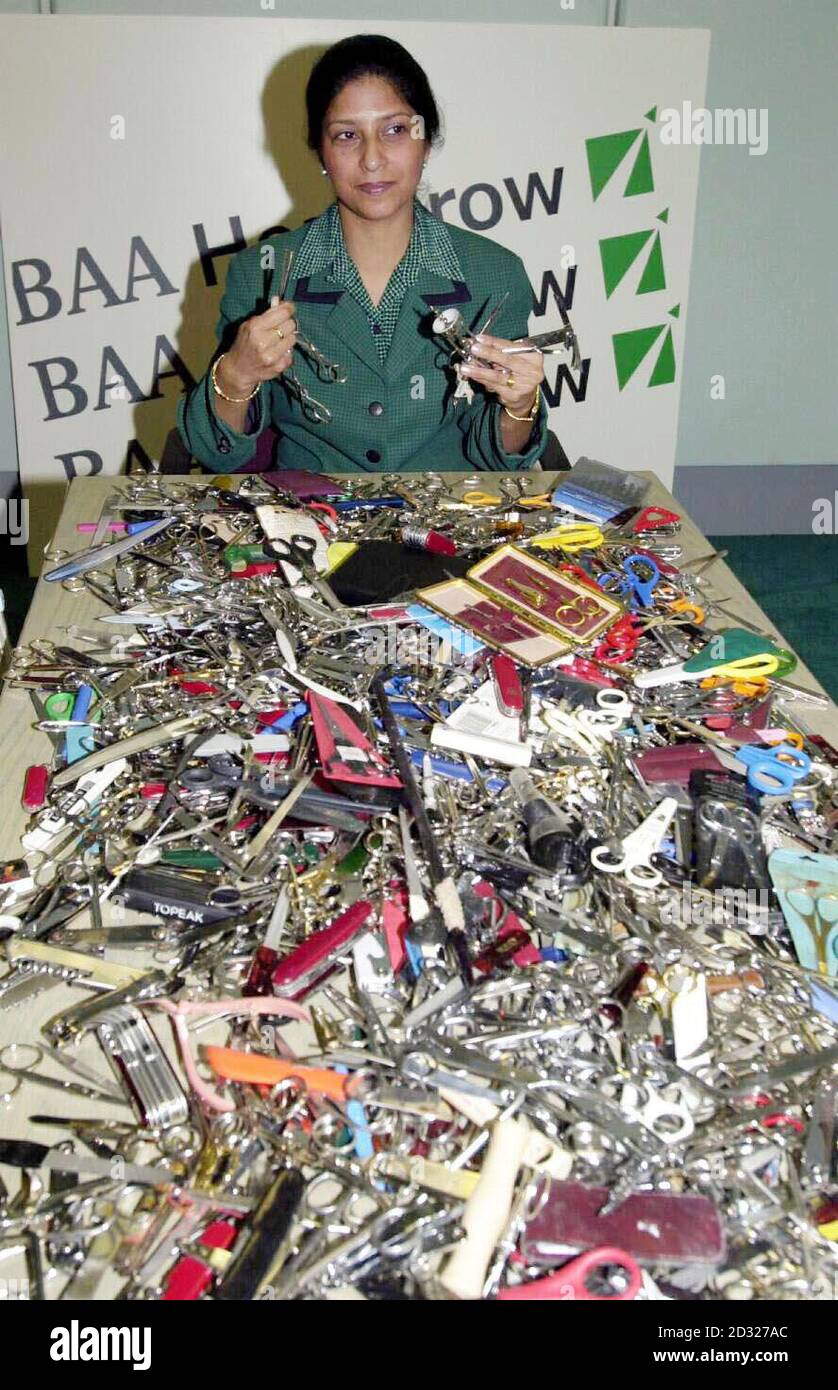 Security guard Sangeeta Cheema  displays some of the sharp objects confiscated from travellers departing Heathrow Airport in London. There has been a security clampdown since the terrorist atrocities in the US last week when knives were used in the hijack of airliners.  Stock Photo