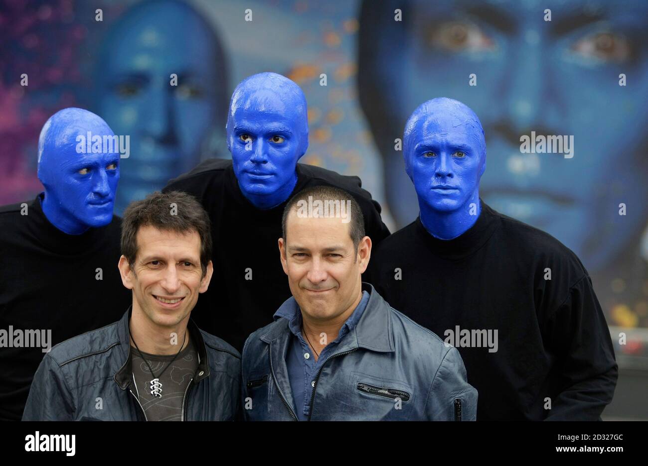 Members of the Blue Man Group pose with their inventors Matt Goldman und  Phil Stanton (R) in front of a giant poster in Berlin May 16, 2008. The  show runs in Berlin