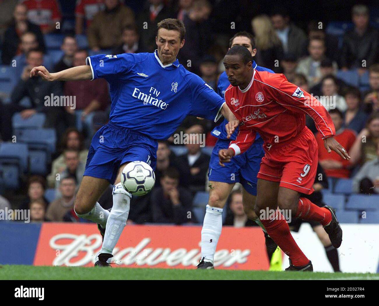 Chelsea's Slavisa Jokanovic clears the ball away from Middlesbrough's Paul Ince during the FA Barclaycard Premiership match at Stamford Bridge, London. THIS PICTURE CAN ONLY BE USED WITHIN THE CONTEXT OF AN EDITORIAL FEATURE. NO WEBSITE/INTERNET USE OF PREMIERSHIP MATERIAL UNLESS SITE IS REGISTERED WITH FOOTBALL ASSOCIATION PREMIER LEAGUE Stock Photo