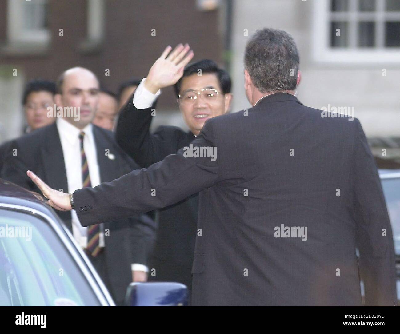 Hu Jintao, the vice-president of China, waves as noisy protesters give him a vocal reception as he arrives in Britain for a five-day state visit.   *...Hu Jintao, tipped as a future Chinese leader, heard boos and cat-calls from Free Tibet and pro-democracy demonstrators while arriving at London's Dorchester Hotel at the start of his five-day visit. The demonstrators were herded into a side street, away from the front of the hotel, but there was no attempt by the police to keep them out of the visiting statesman's view or to pull down banners critical of the Chinese government - as happened whe Stock Photo