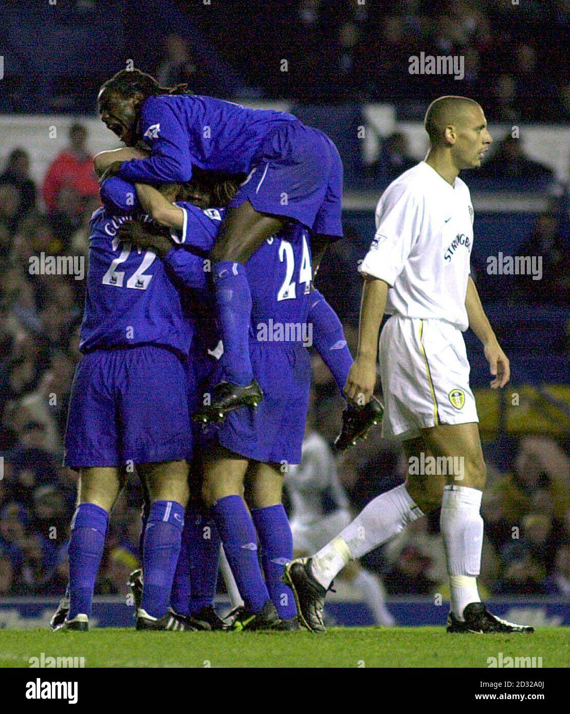 Leeds United's Rio Ferdinand (right) walks past dejected as Chelsea's Eidur Gudjohnsen is embraced by team-mates after scoring the first goal during the Worthington Cup, fourth round game between Leeds United and Chelsea at Elland Road, Leeds.  THIS PICTURE CAN ONLY BE USED WITHIN THE CONTEXT OF AN EDITORIAL FEATURE. NO WEBSITE/INTERNET USE UNLESS SITE IS REGISTERED WITH FOOTBALL ASSOCIATION PREMIER LEAGUE.  Stock Photo