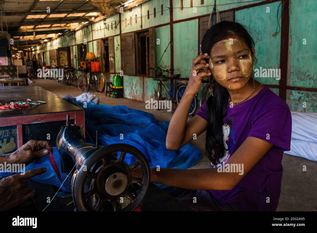 Burmese girl working on sewing in the local market Stock Photo