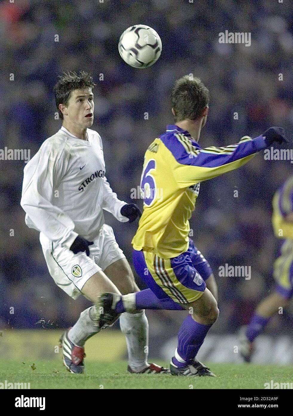 Arsenal's Giovanni Van Bronckhorst slips the ball through the legs of F.C Schalke's Victor Agali (left) during the UEFA Champions League Group C game between Arsenal and Schalke at Highbury, London. Stock Photo