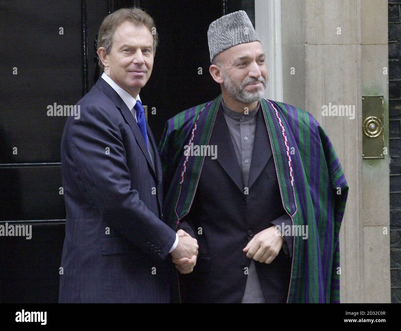 British Prime Minister Tony Blair (left) meets Afghanistan's Interim Leader Hamid Karzai in Downing Street, London during a visit to Britain. Speaking in the Cabinet Room at 10 Downing Street Hamid Karzai thanked Britain and its allies for giving his country back to its people.  * .... and liberating it from the occupying force of the Taliban and its terrorist allies. He is only the second foreign leader after Bill Clinton to be given the privilege of addressing ministers there. Stock Photo