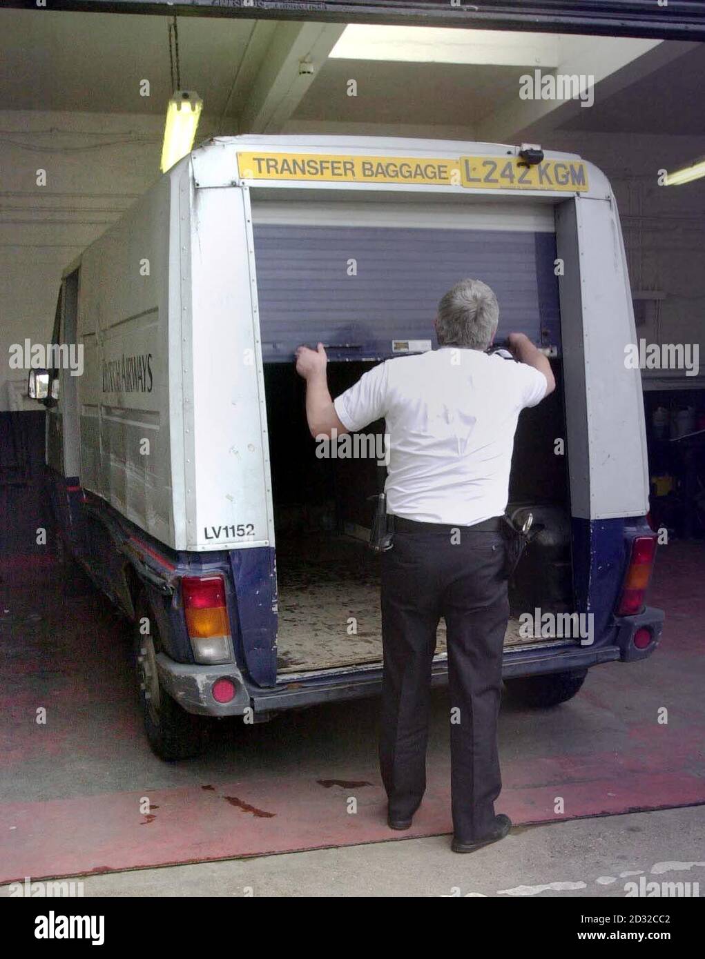 A police officer at Hayes police station inspects a van used by robbers who attacked a BA security van in a secure airside cargo loading area near Heathrow Airport's Terminal 4 , and who escaped with  4.6 million.    *  The vehicle was subsequently found abandoned and burning two miles away in a residential area in Feltham, west London.  Government ministers responsible for aviation security have ordered a report on how thieves managed to gain access to the airport's restricted zone during a period of heightened security in the wake of events on September 11. Stock Photo