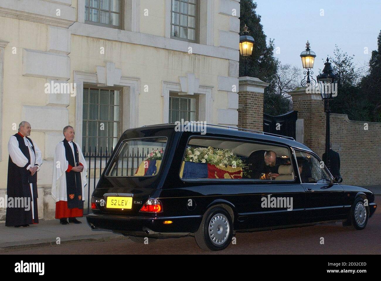 Members of the clergy watch as the hearse carrying the coffin of Princess Margaret - the younger sister of Britain's Queen Elizabeth II  -  leaves from The Queen's Chapel at St James's Palace for the journey to Windsor Castle.  * ...  where her funeral will take place at St George's Chapel.  The Princess died aged 71. Stock Photo