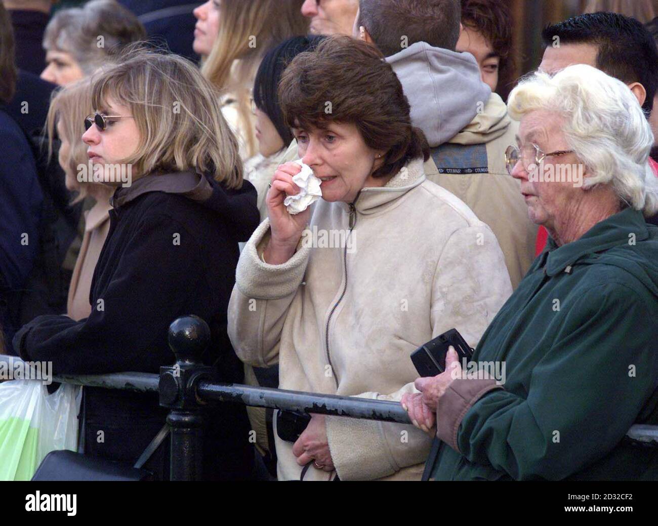 Mourners watch the hearse carrying the coffin of Princess Margaret leave Windsor Castle after a funeral service in St George's Chapel. The Princess was being driven to Slough Crematorium where she was being cremated. Stock Photo