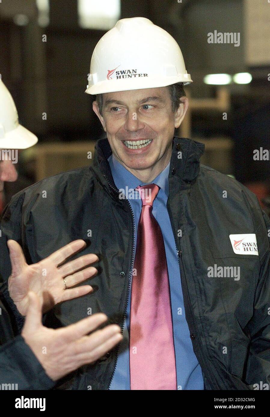Prime Minister Tony Blair wears a safety hat during a visit, to the Swan Hunter shipyard at Tyneside.  Work has begun at the yard on Ministry of Defence orders to build two vessels for the Royal Fleet Auxiliary.  * ... and yard chairman Yaap Kroese said the firm, which employs more than 700 people, was in the running to increase its order book. Stock Photo