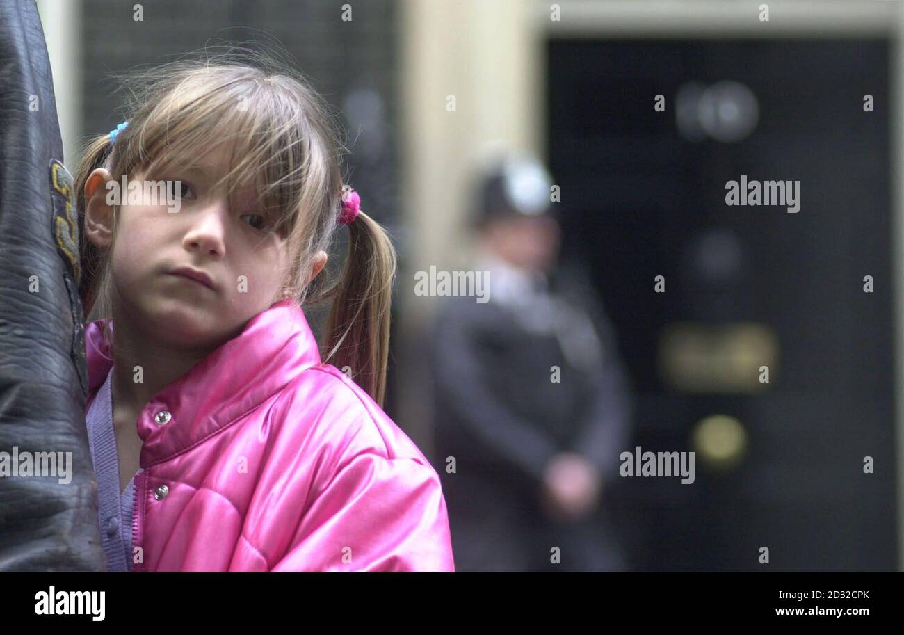 Charlotte Payne, 7, sister of murdered schoolgirl Sarah, stands with her mother, Sara, outside No 10 Downing Street, central London, after a letter had been handed in requesting a meeting with Prime Minister, Tony Blair.  * ... urging the government to provide more support for the families of murder victims. Sara Payne joined other relatives of murder victims, all brought together by the Victims of Crime Trust. Stock Photo