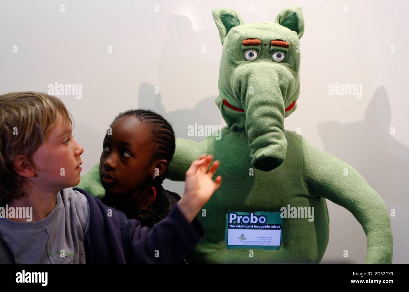 Children pose with Probo, the intelligent "huggable" robot, at the unveiling the first prototype April 21, 2009. Probo was designed to interact with humans and will in providing