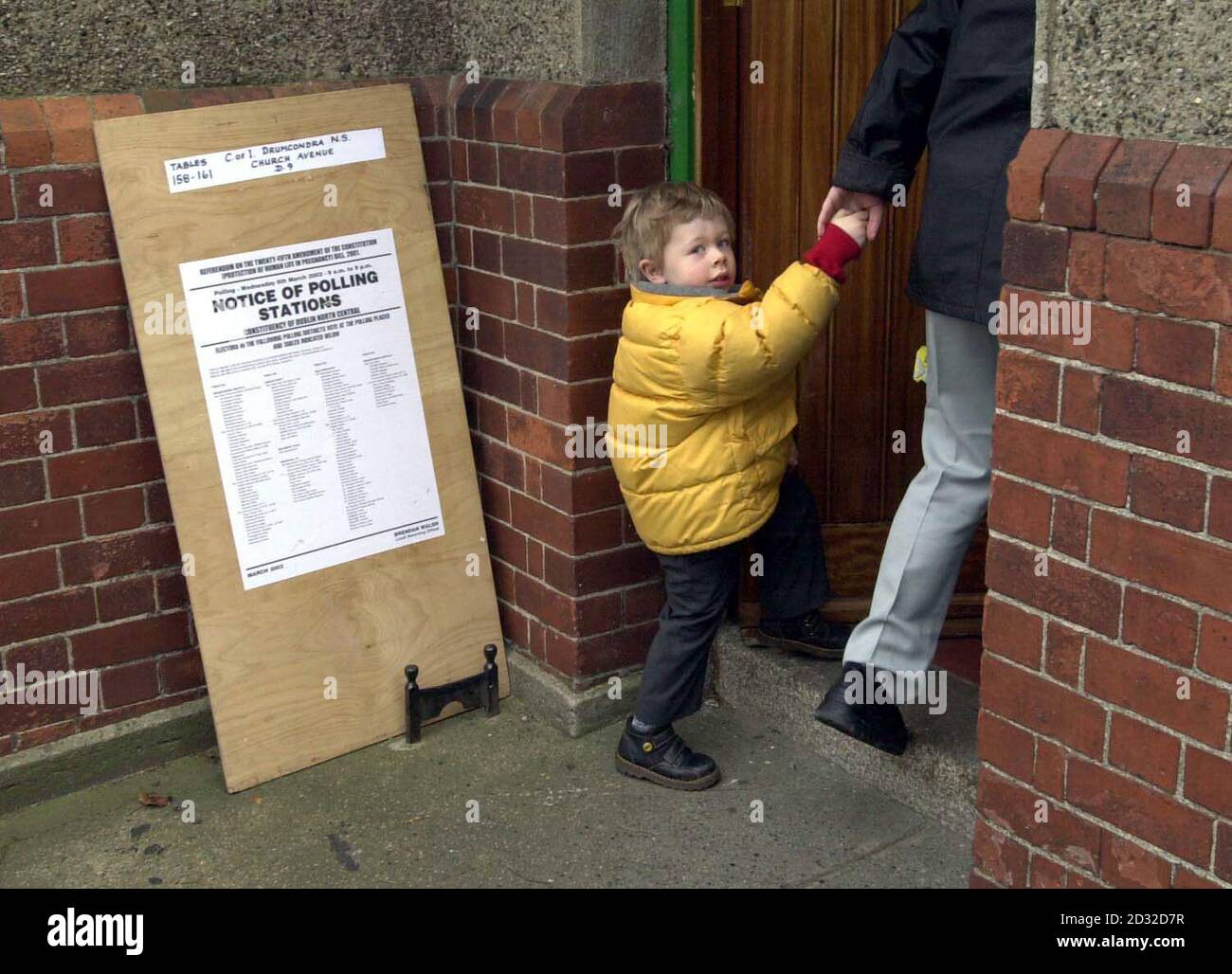 A mother and her child walk into a polling station in Drumcondra, North Dublin for the referendum on abortion. The current law outlaws abortion unless a woman's health is in grave danger from continuing with the pregancy.   * A 'Yes' vote would back a proposal guaranteeing the ban on abortion, except in cases where the life of a mother is considered to be at risk, but rules out the threat of suicide as a reason for termination. A 'No' vote would mean that the constitution would not change, and that the original Supreme Court ruling to allow abortions in such exceptional circumstances would sta Stock Photo
