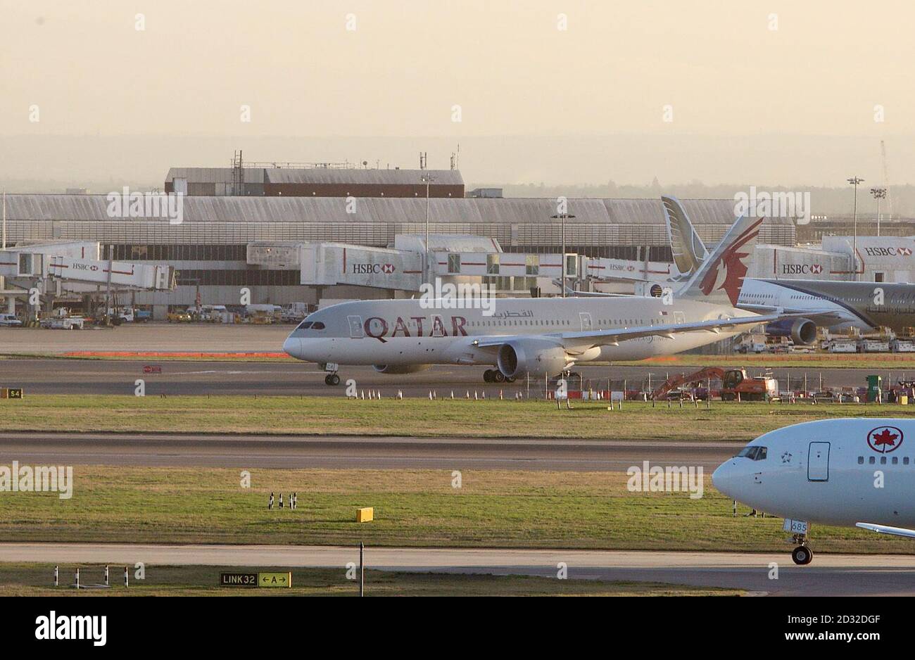 A Qatar Airways Boeing 787 Dreamliner taxies at Heathrow Airport in London. Stock Photo