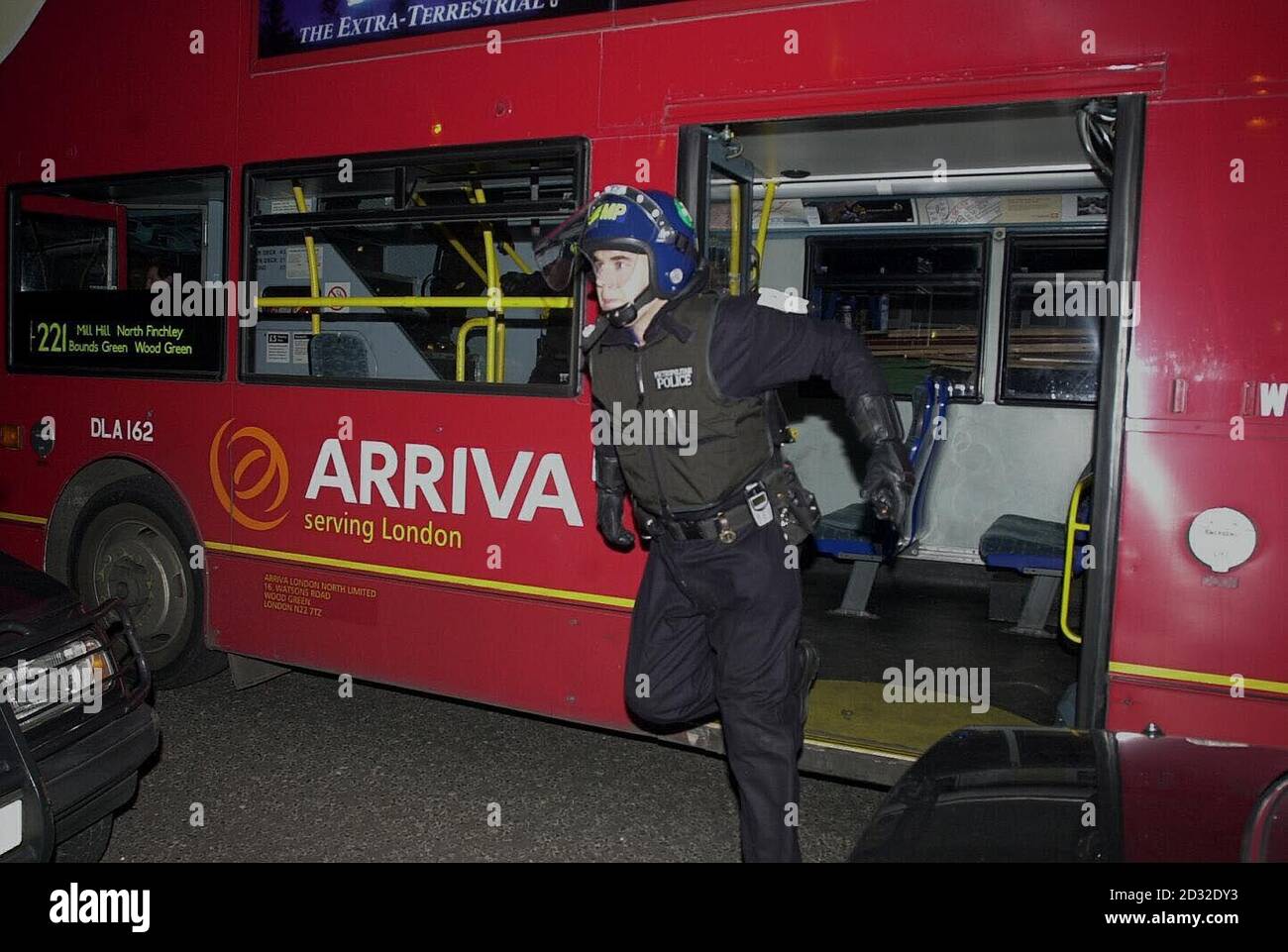 Not the usual mode of transport for a policeman arriving by bus for a drugs raid on the Sparrow Public House, Edgware, North London. Stock Photo
