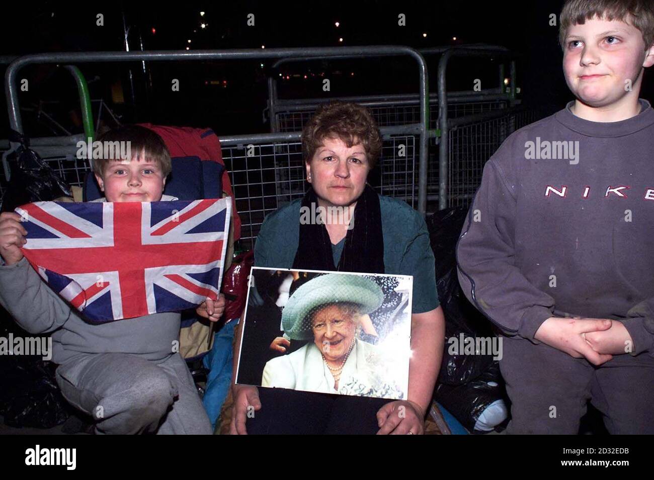 Jennifer Hawkins, from Worthing Sessex, flanked by brothers Christopher (left) and Thomas Pont from Attlebrough Norfolk, camped on the pavement outside The Palace of Westminster, in anticipation of the procession of the Queen Mother's coffin.  *... which is to lie in state in the Great Hall, until her funeral. Stock Photo