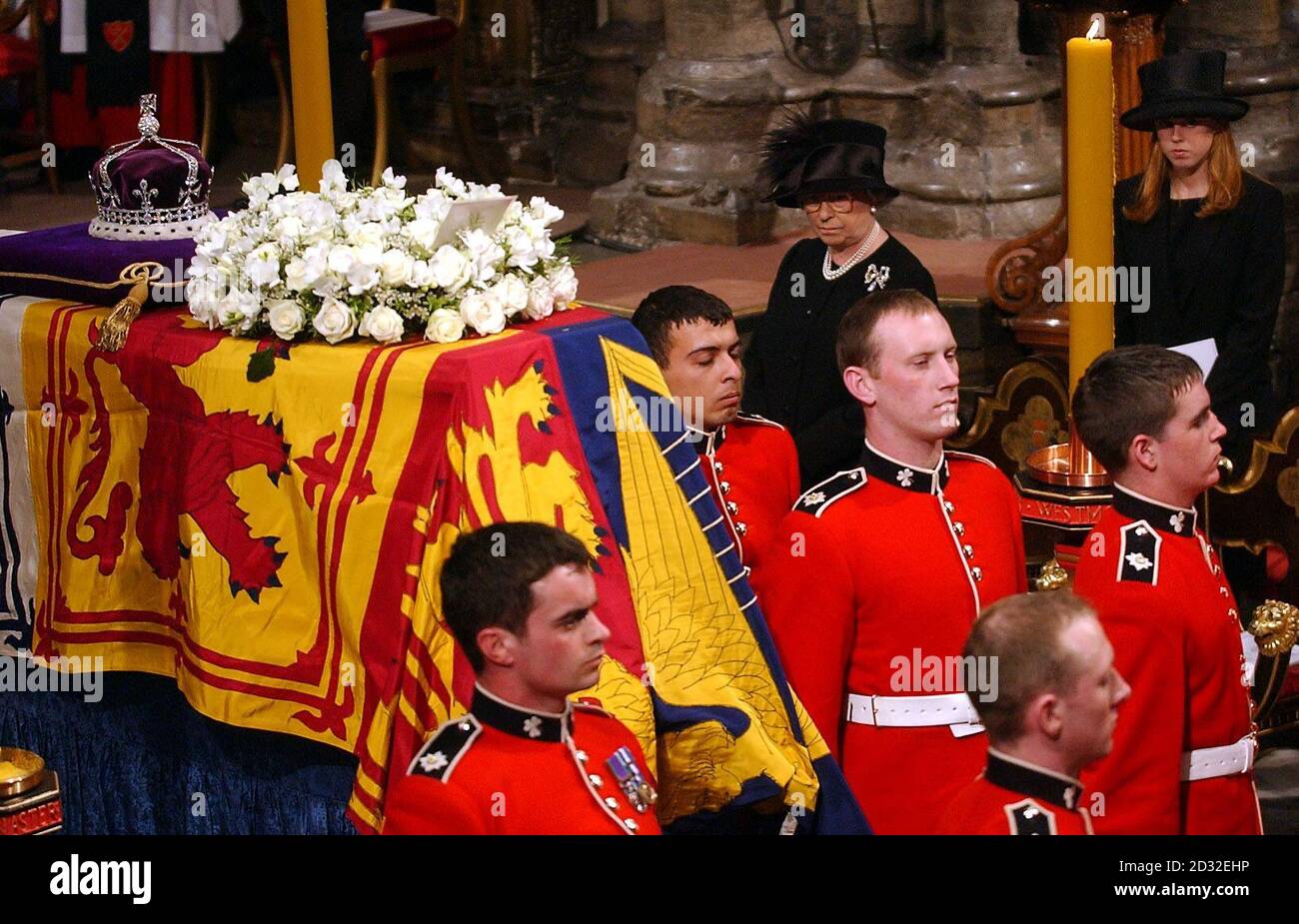 Queen Elizabeth II watches looks at pallbearers after they placed the