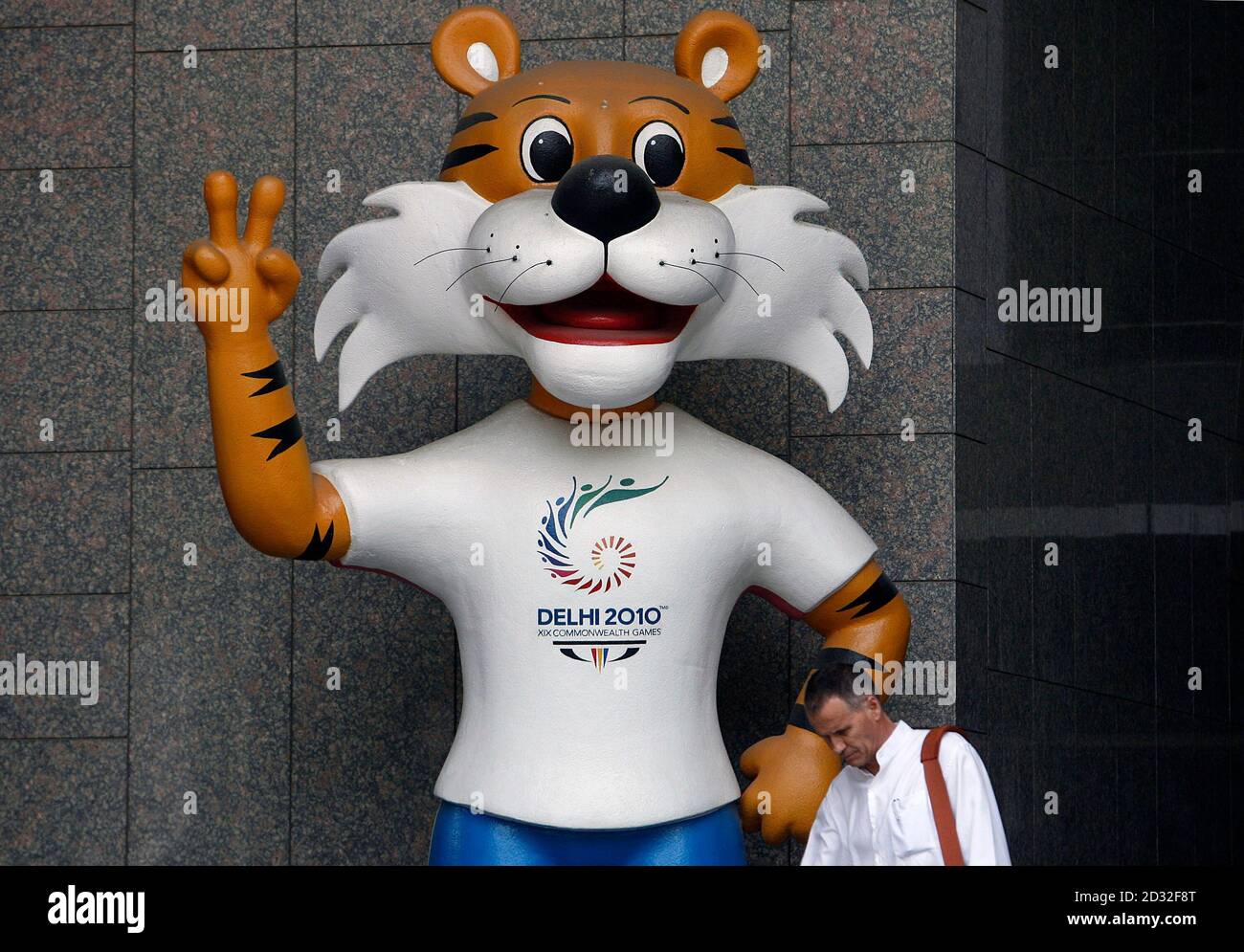 A commuter walks past the New Delhi Commonwealth Games 2010 mascot in New  Delhi October 3, 2009. The head of the Commonwealth Games Federation (CGF)  believes there are "enormous" challenges facing the