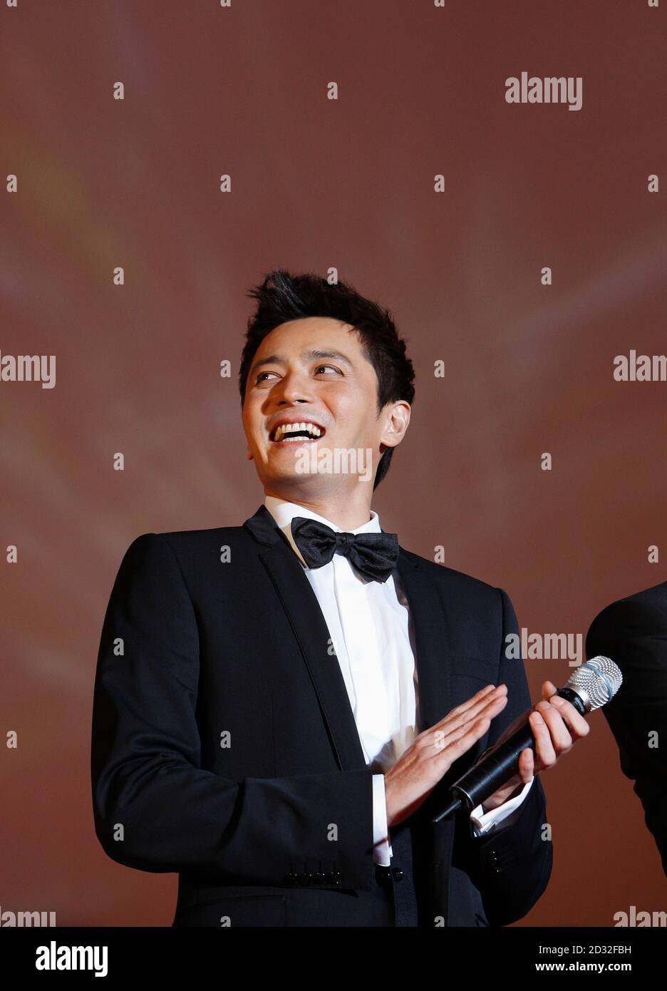 South Korean actor Jang Dong-gun from the movie "Good Morning President" reacts as he introduces his movie at the opening ceremony of the 14th Pusan International Film Festival in Busan, about 420 km (262 miles) southeast of Seoul, October 8, 2009.  REUTERS/Jo Yong-Hak (SOUTH KOREA ENTERTAINMENT) Stock Photo
