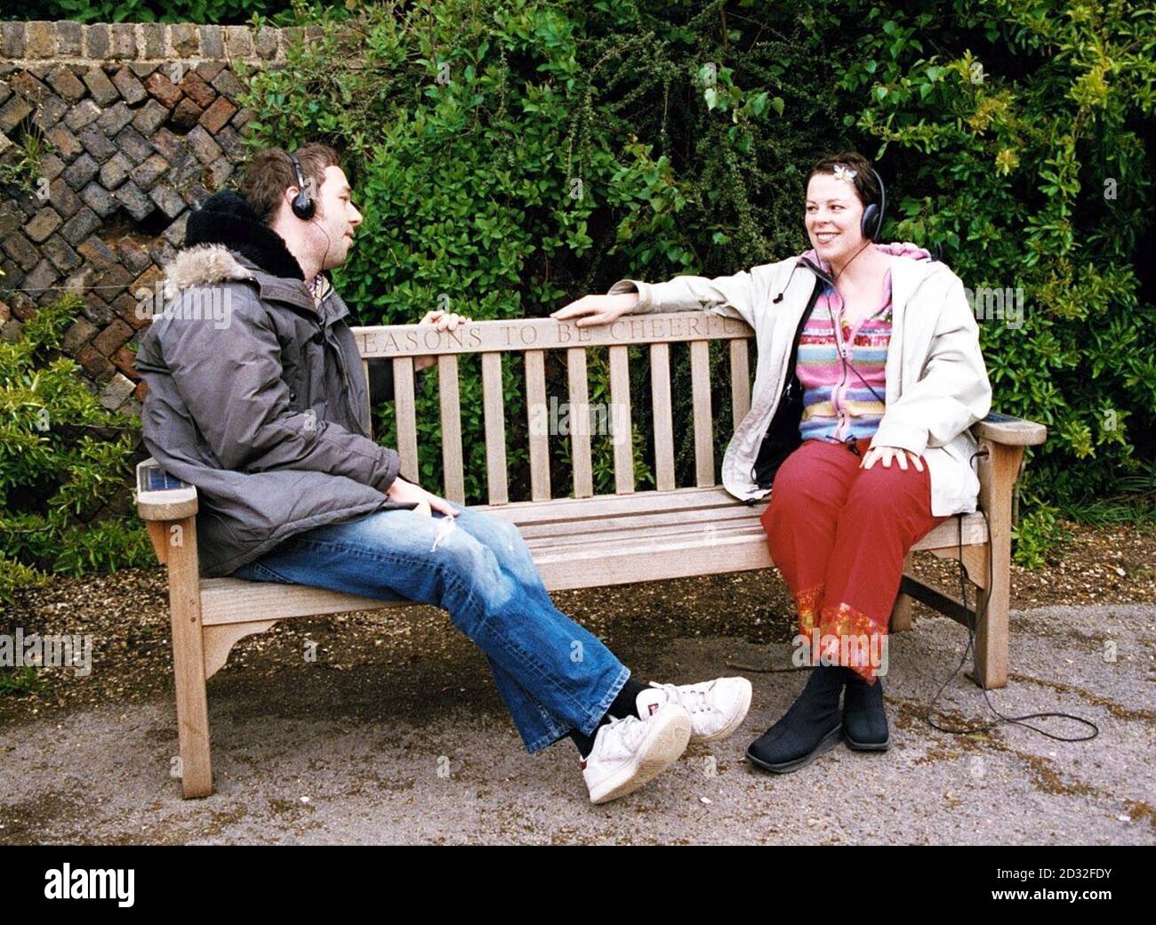 Singer Ian Dury's children, Baxter (left) and Jemima test a new solar-powered bench at Poet's Corner within the grounds of Pembroke Lodge in Richmond Park.   *  The bench donated by Dury's family and designed by Mil Stricevic will enable people to listen to the music of Ian Dury whilst enjoying the views of the park. Stock Photo