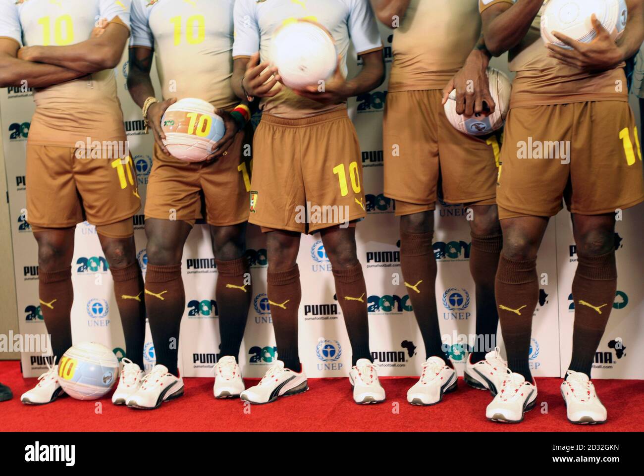 Members of the Cameroon's national football team wear the PUMA Africa Unity  Replica jersey during a news conference in Kenya's capital Nairobi, January  6, 2010. PUMA and the United Nations Environment Programme (