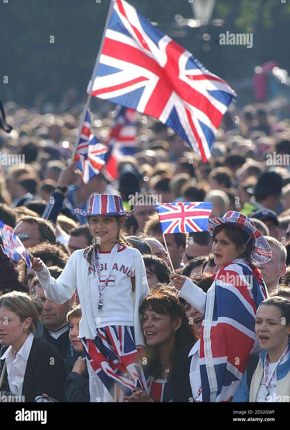 Squeezing in, crowds take every vantage point around Buckingham Palace, for the Pop Concert to celebrate the Golden Jubilee of the Queen.  The Jubilee spectacular will be kicked off with Queen guitarist Brian May performing the National Anthem from the roof.  *   of the Palace. Stock Photo