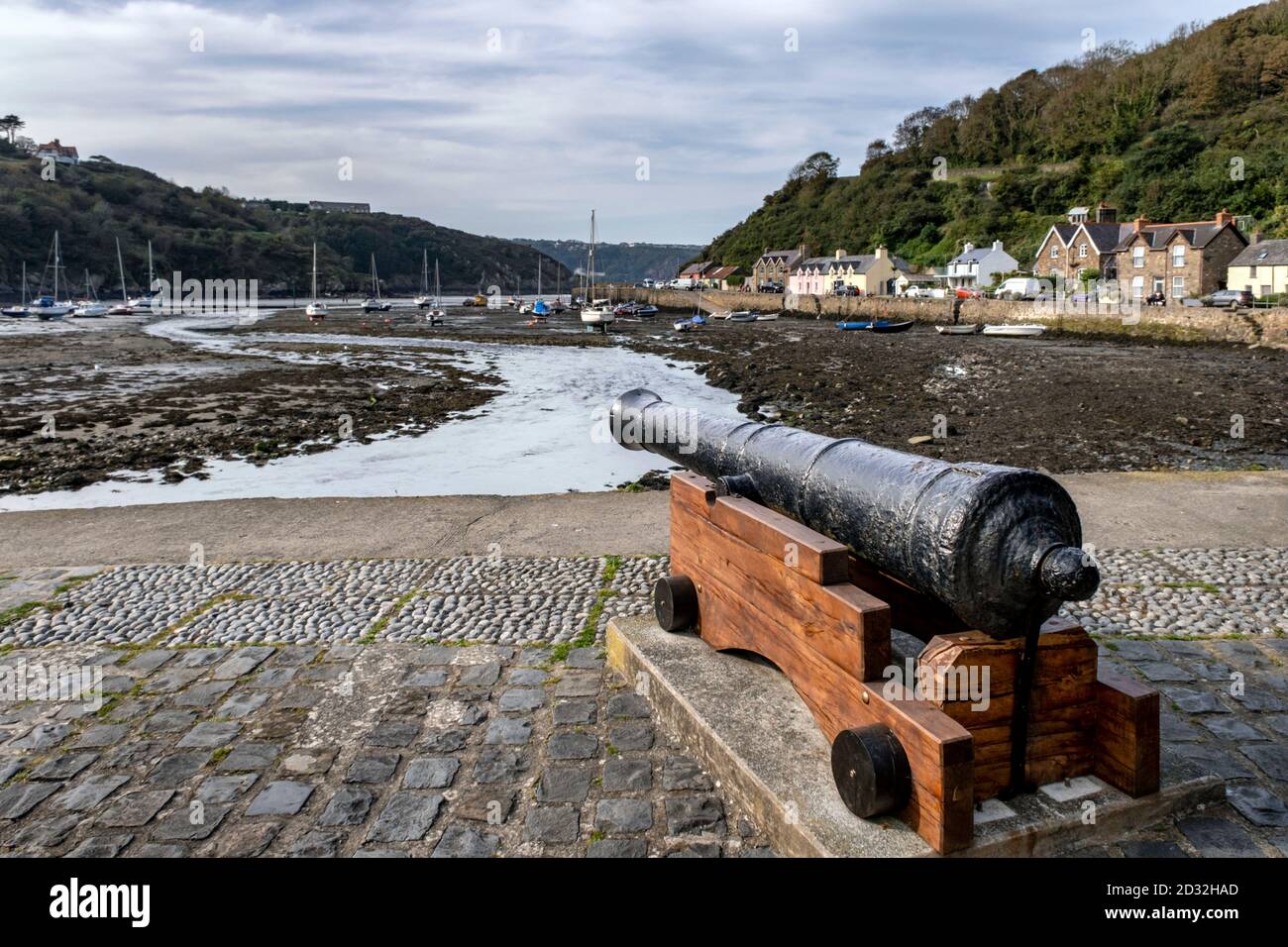 An old naval cannon beside the harbour at Lower Fishguard, Pembrokeshire, Wales, UK Stock Photo