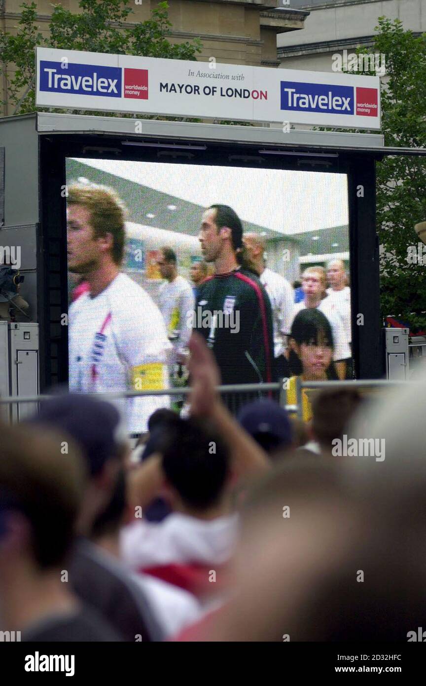 Engand football fans watch the pre-match scenes on a giant screen in Trafalgar Square in central London before kick-off in their team's match against Brazil in the Quarter-Final tie of the World Cup.  * The game, being played in Japan's Stadium Ecopa in Shizuoka, is the first time that the two teams have met in the World Cup since Brazil's 1-0 defeat of England in the infamous Mexican World Cup of 1970.   Stock Photo