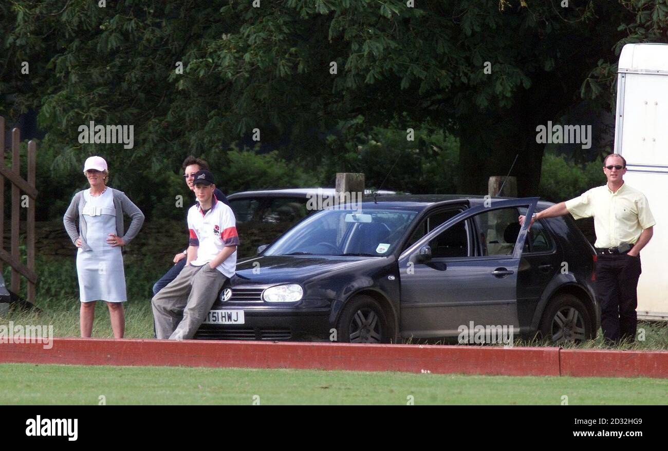 Prince Harry sits on the bonnet of his car - sitting out on the polo match that is father Prince Charles and brother Prince William participated in at Beaufort Polo Club. Stock Photo