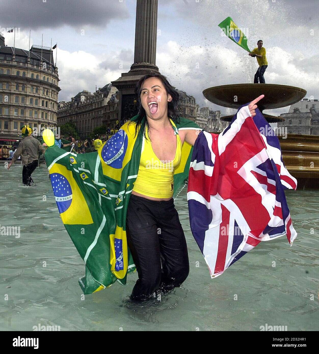 A young Brazilian fan celebrates in a fountain in Trafalgar Square, London. Brazil defeated Germany 2-0 in Yokohama, Japan to win the World Cup for the fifth time, Ronaldo scoring twice in the second half to give his team victory. Stock Photo