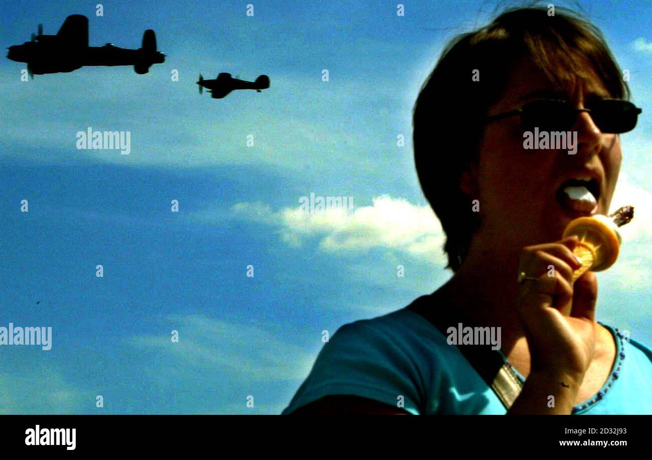 Kate Warboys from Meldreth has an ice cream during the Flying Legends Air Show at Duxford in Cambridgeshire.     *Thousands of aviation enthusiasts and families today visited the second day of an annual showcase of First and Second World War aircraft, featuring dozens of aircraft, pilots and combat veterans from across the world. Stock Photo