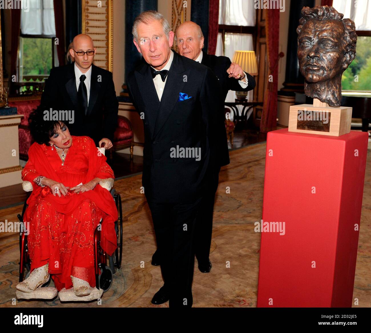 Prince Charles and actress Elizabeth Taylor (L) look at a bust of Welsh  actor Richard Burton (R) during a Royal Welsh College gala evening at  Buckingham Palace in London April 29, 2010.