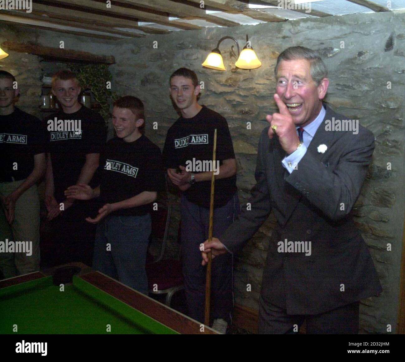 The Prince of Wales, Prince Charles, celebrates potting a ball in the Dudley Arms pub during his visit to Llandrillo in north Wales. Stock Photo