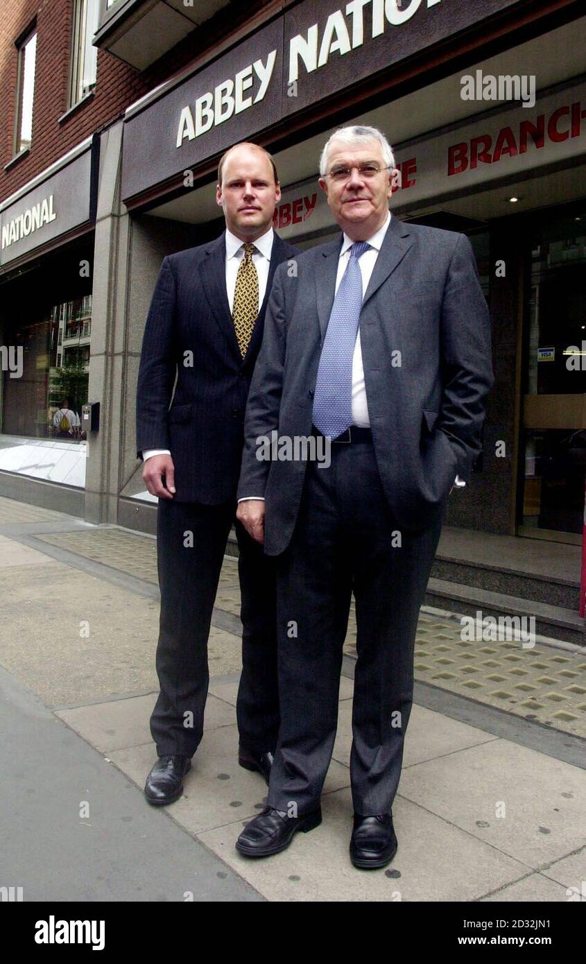 Chairman of Abbey National Lord Burns (right), standing with Finance Director Stephen Hestor during a photocall at Abbey National's London Headquarters, Abbey House, central London.   *Banking group Abbey National detailed the problems which cost chief executive Ian Harley his job by unveiling a 34% slide in half-year profits, Wednesday July 24, 2002. The company, which parted company with Mr Harley last Friday, primarily blamed the fall on  208 million worth of bad debt provisions linked to investments at its corporate-based wholesale arm. That left pre-tax profits for the six months to June  Stock Photo