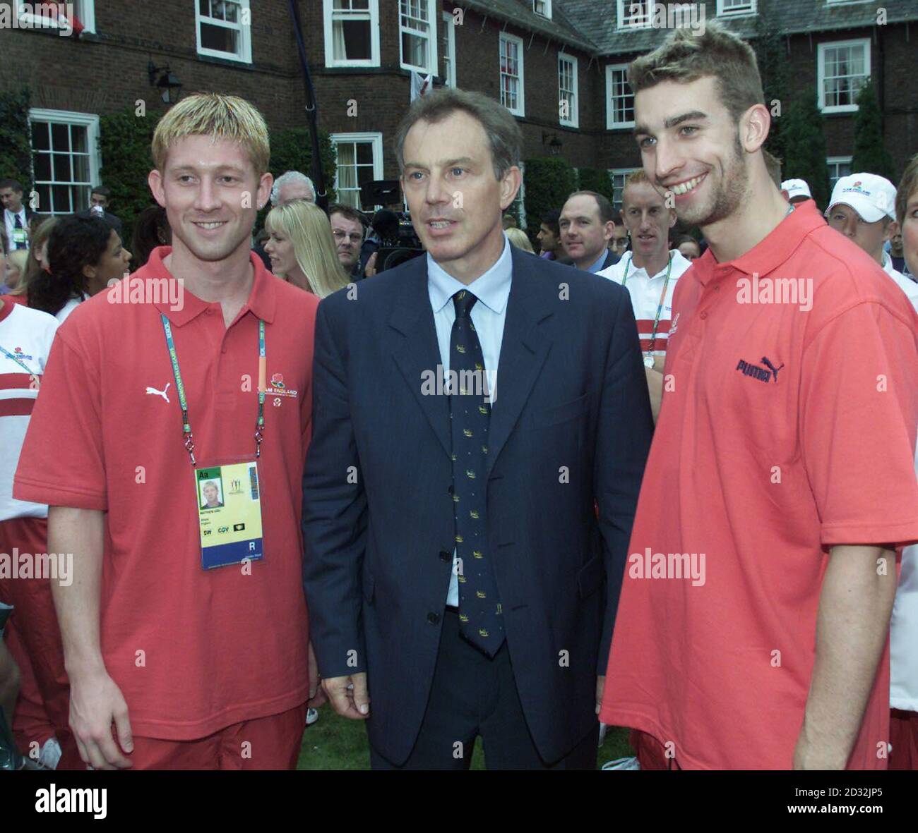 The Prime Minister Tony Blair MP stands with English team members  Matthew Kidd (L) and James Gibson (R) at the  Athletes village which he visited before attending the opening ceremony for the 2002 Manchester Commonweatlth Games. Photo Tom Hevezi/PA. Stock Photo