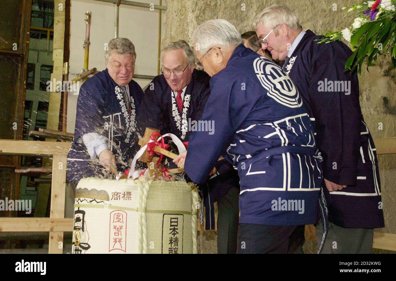 Bosses for the Channel Tunnel Rail Link (CTRL) including Project Director for Rail Link Engineering Roger Picard (left) and Managing Director of Union Railways (North) Walt Bell (2nd left) break into a barrel of sake - a Japanese rice liquor.  * ....  - as a good luck omen for the rail link at one of the sites currently under construction as a new international station, Stratford in east London. The two boring machines, Annie and Bertha, will begin work on the 17.5km route from Stratford to St Pancras in central London, with Annie starting today and Bertha beginning in six weeks time. Stock Photo