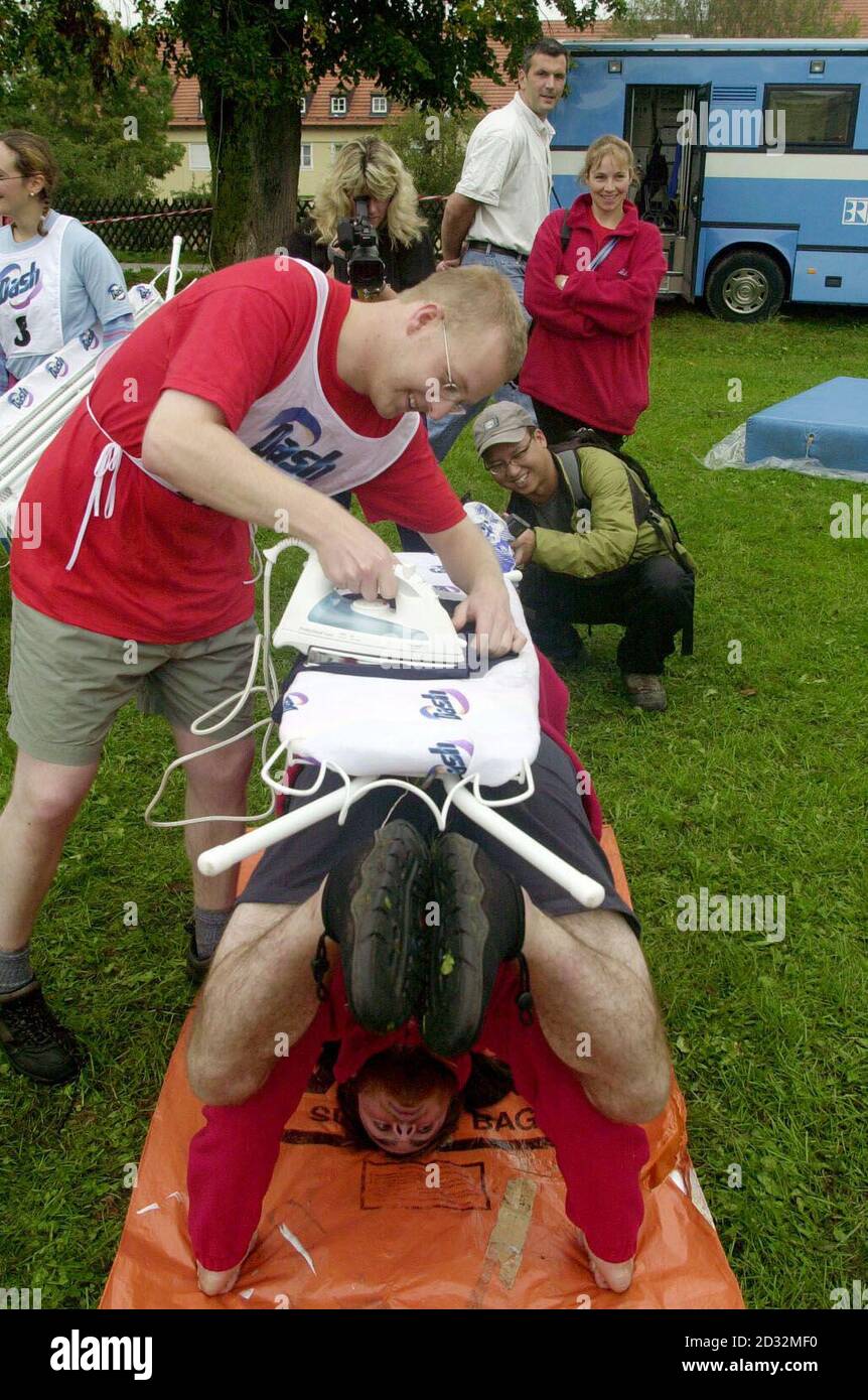David Fitzgerald, aka 'Safety Setting', 26, an Environmental Health Officer from Chichester, irons a pair of boxer shorts helped by team-mate Jo 'Ironside' Sterling, 19, a student from Leicester, * during the free-style section of the Extreme Ironing World Championships being held near Munich in Germany, Saturday September 21 2002. David and Roger are two of 12 UK competitors, sponsored by Rowenta, in what is the first world championships to be held in the sport. Team-mate Phil 'Steam' Shaw invented the sport in 1997 when he decided to combine the mundane chore of ironing with his love of r Stock Photo