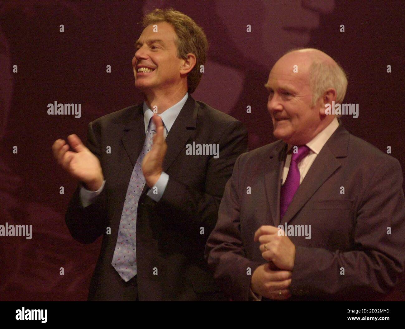 Prime Minister Tony Blair and the Secretary of State for Northern Ireland John Reid applaud the audience at the end of the Labour Party Conference in Blackpool. Stock Photo