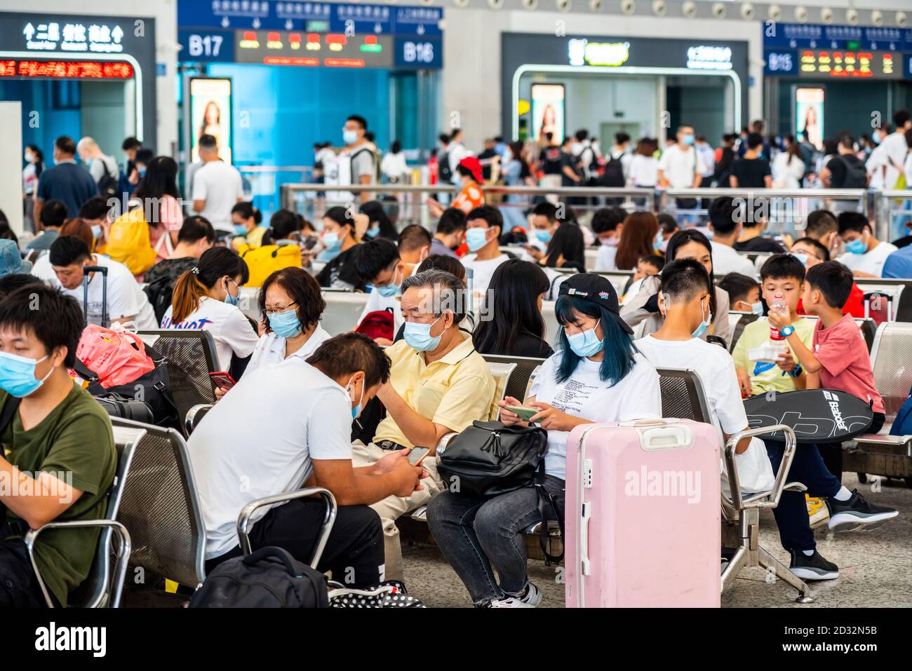 Several Chinese Travelers Wearing Facemasks Are Seen Seated In Departure Halls At Shenzhen North Railway Station As They Finish The National Day Holiday In China Which Is Also Known As The Golden Several Chinese Travelers Wearing Facemasks Are Seen Seated In Departure Halls At Shenzhen North Railway Station As They Finish The National Day Holiday In China Which Is Also Known As The Golden