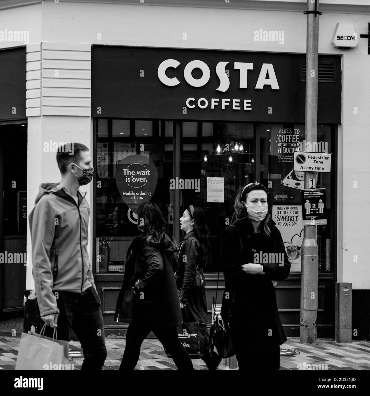 London UK October 06 2020, Group Of People Walking PAst A Branch Of High Street Coffee Shop Costa Wearing Face Coverings Stock Photo
