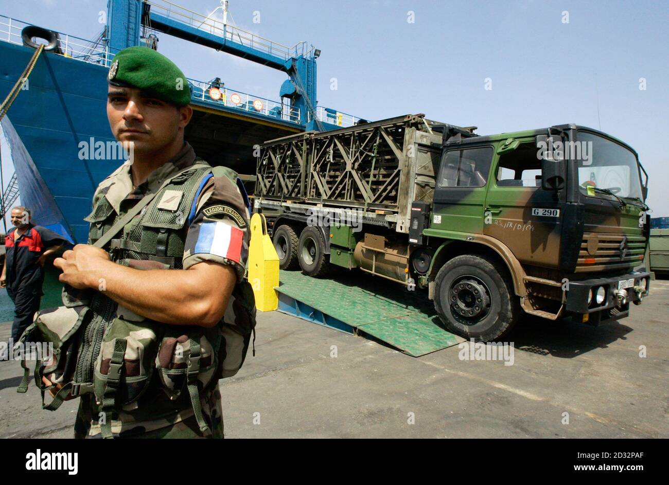 A French Foreign Legion Soldier Of The 2nd Corps Of Engineers Stands As Mobile Bridges Are Unloaded In Background At Beirut Harbour August 29 06 Some Two Hundred And Forty Soldiers Arrived