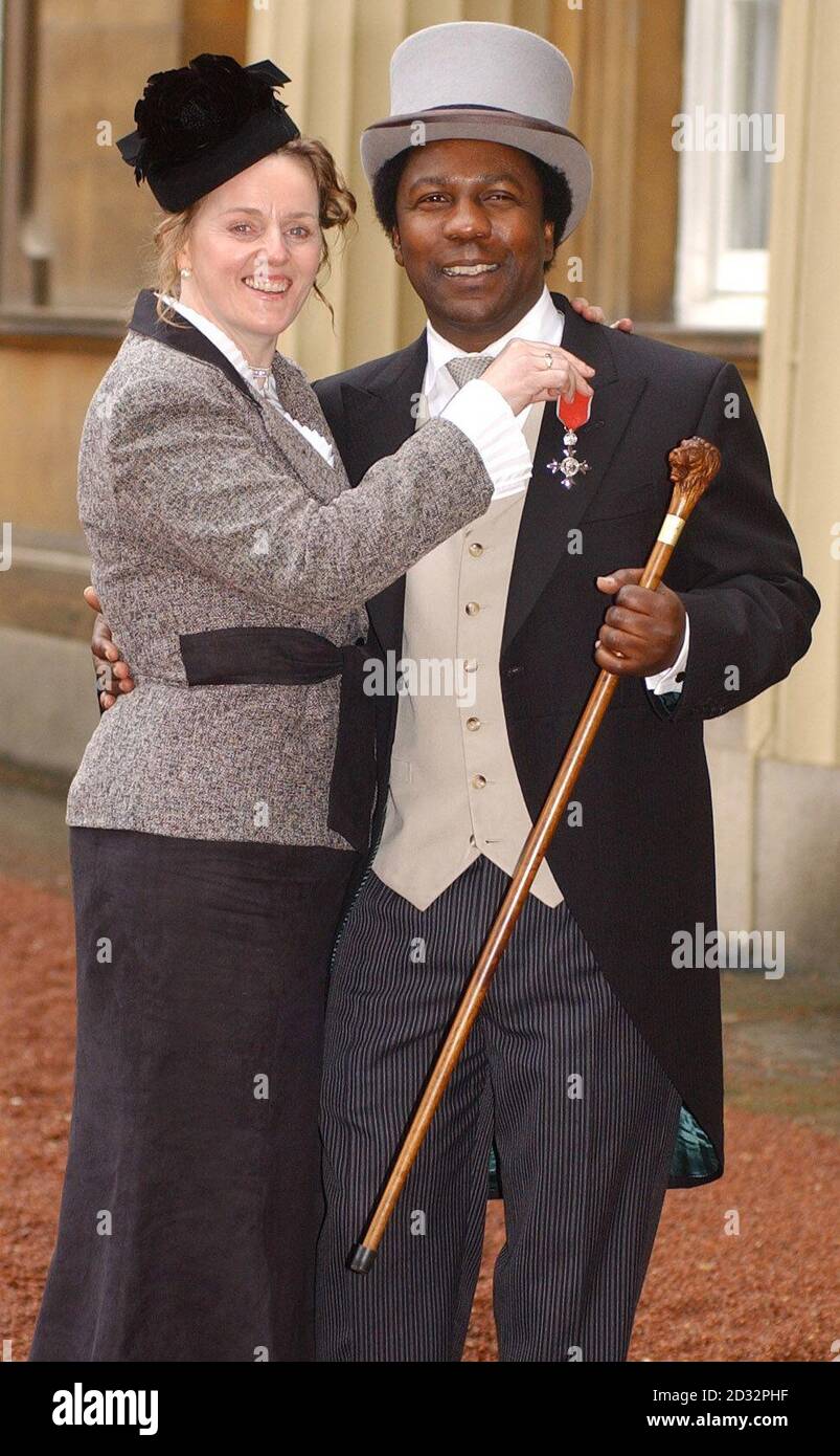 DJ Norman Jay and his wife Marie from west London  pose with the MBE that Norman was awarded at Investitures at Buckingham Palace at Buckingham Palace. Jay was among some 150 people who received awards from the Queen at Buckingham Palace. Stock Photo