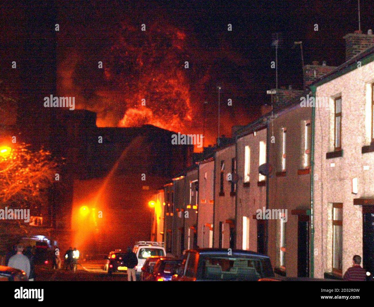 Residents of a street in Rochdale stand and watch as a large fire destroys a tyre factory in the town.    *  Army fire crews try to control the huge fire with the appliances provided to them on the Green Goddess trucks, with the national fire service currently undertaking their eight day strike. Stock Photo