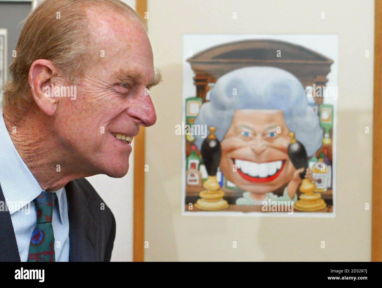 The Duke of Edinburgh looks at a cartoon of Britain's Queen Elizabeth II standing behind the bar in the Old Vic pub from TV show Eastenders drawn by Trogg for the Golden Jubille.  * The Duke was on a visit to the Cartoon Art Trust's Kings and Queens exhibition at the Mall Galleries, London, of which he is a patron. Stock Photo