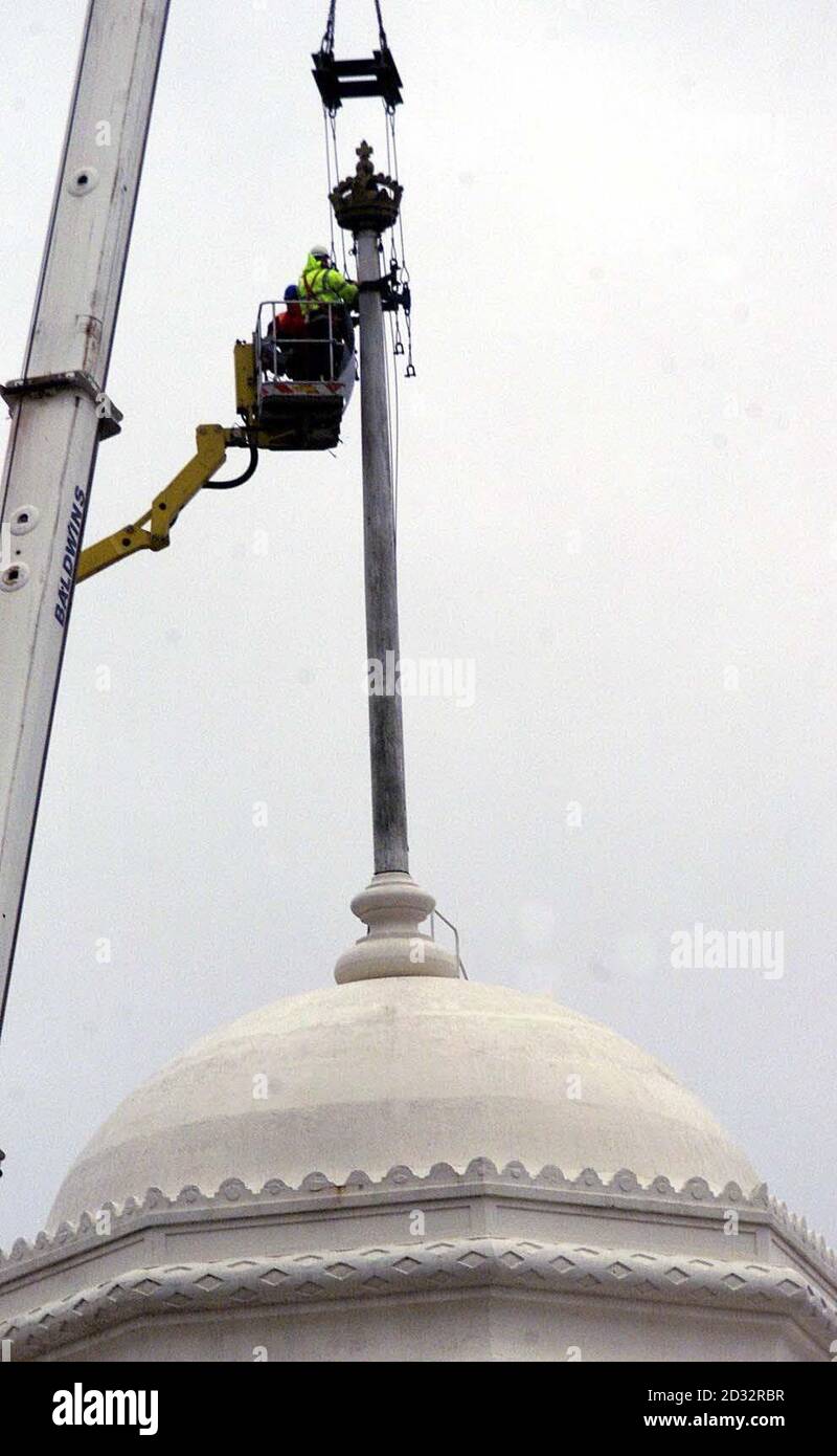 Workers get ready to remove a crown from the top of a flag pole on a twin tower at wembley stadium. Stock Photo