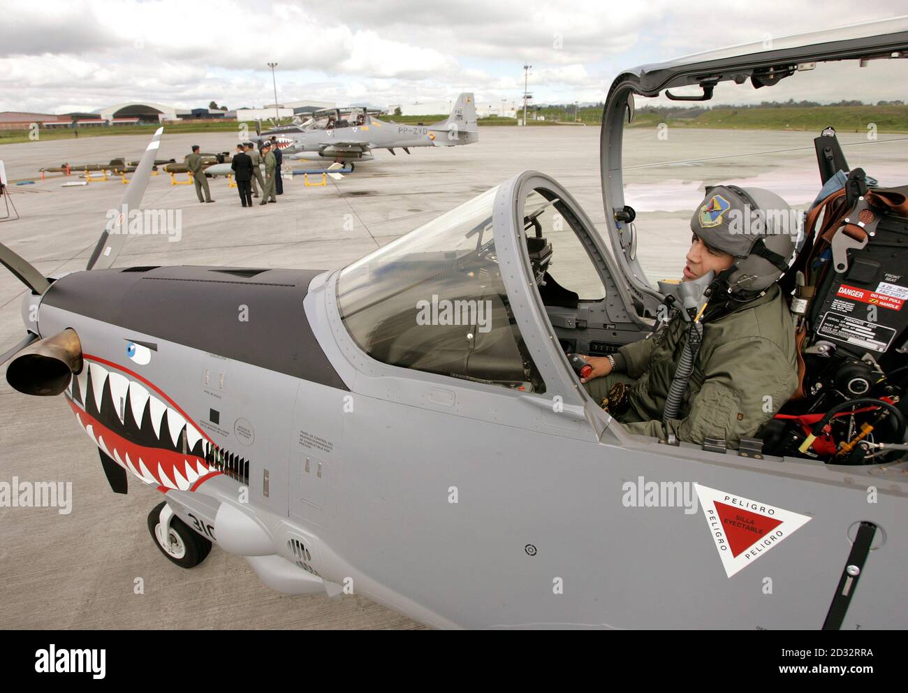 A Colombian airforce pilot sits in a Tucano turboprop plane at Bogota's military airport of Catam, December 14, 2006. Brazil delivered three military planes in Colombia in a move that Colombia's biggest rebel group characterized as meddling in its four-decade fight to establish a socialist state. The Super Tucano turboprop planes, made by Embraer, are part of a bigger order of 25 aircraft worth $235 million.  REUTERS/Jose Miguel Gomez         (COLOMBIA) Stock Photo