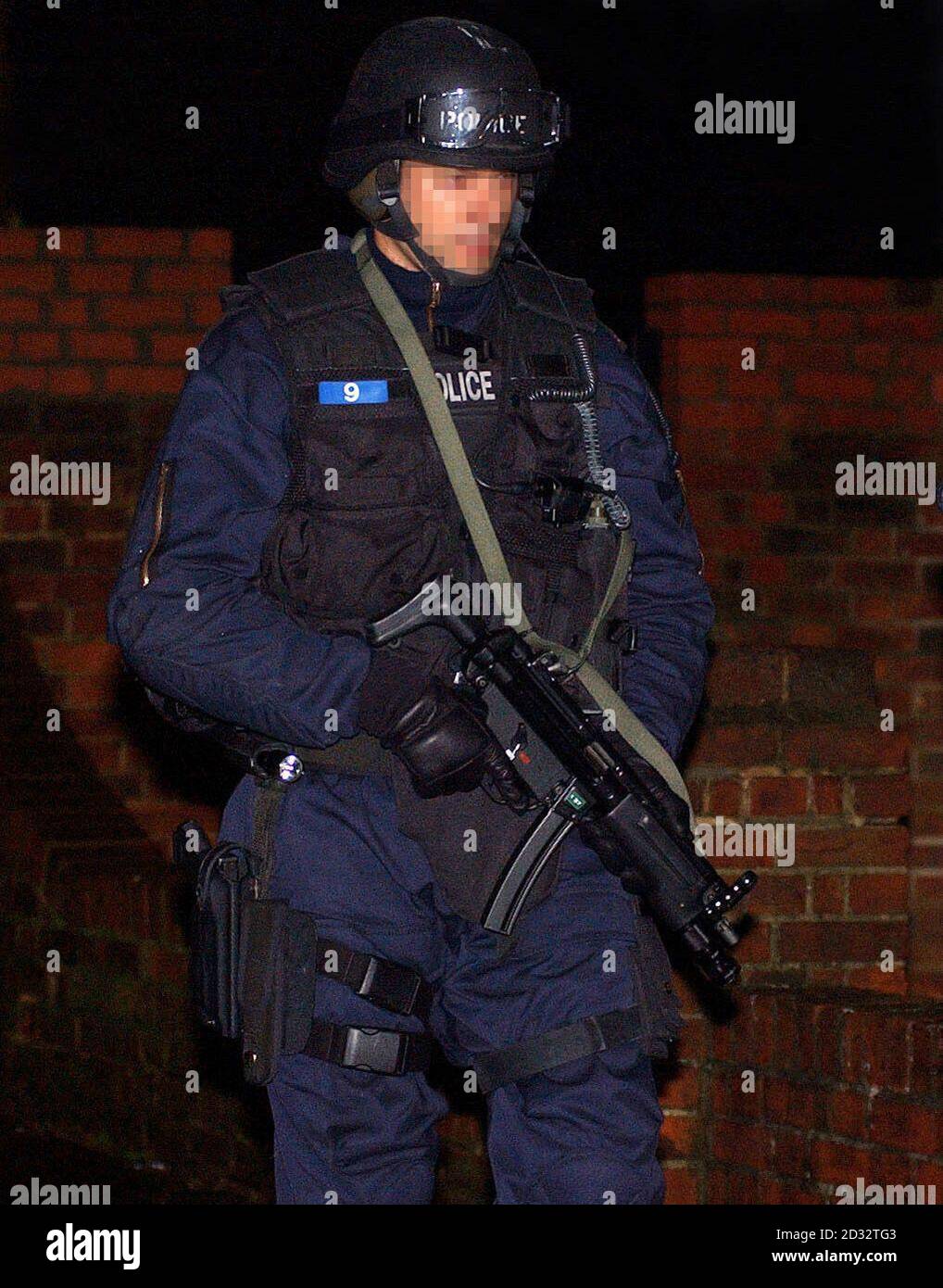 An armed police officer in Edgware, north London, during an overnight operation as Scotland Yard launched a series of co-ordinated raids on what they described as probably the biggest organised crime group in the UK.   *  500 officers raided homes, businesses and gambling dens linked to a notorious Turkish family who are described as 'kingpins' in the international heroin smuggling trade with interests in the UK, Turkey, Holland and the rest of Europe. Stock Photo