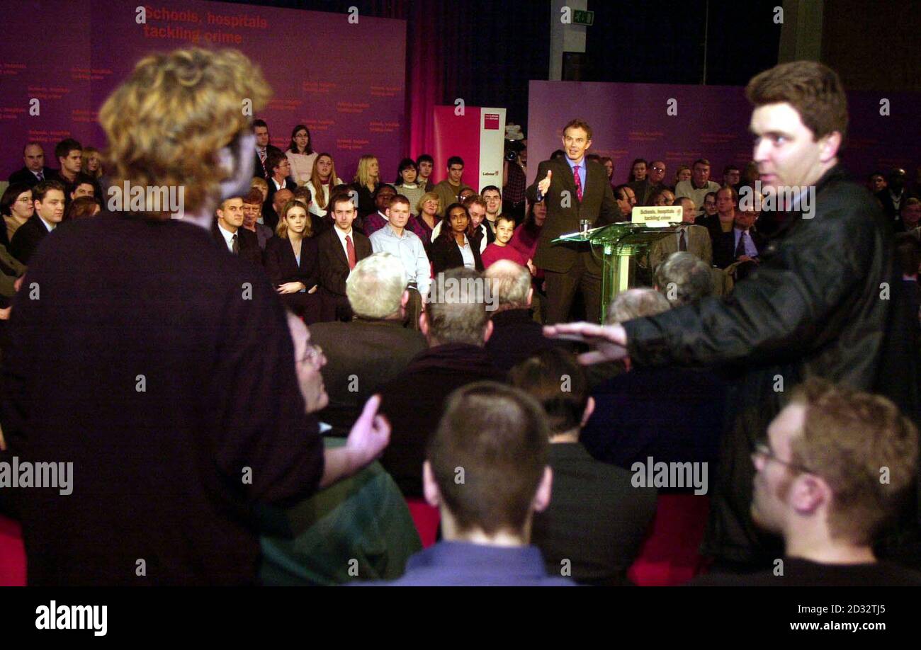 Prime Minister Tony Blair attempts to answer accusations thrown at him by London School of Economics student Ian Wilson (left).   *  Less than 20 minutes into his speech at South Camdem Community School this evening, Mr Blair was interrupted by a heckler who stood up and started shouting out against a war on Iraq. 24/01/03 : Tony Blair was focusing on the Government s domestic agenda at a meeting of the political Cabinet in Downing Street. The Prime Minister saw his attempt to drag attention off Iraq and on to public services ambushed last night. He had hoped to persuade voters that the Iraq c Stock Photo