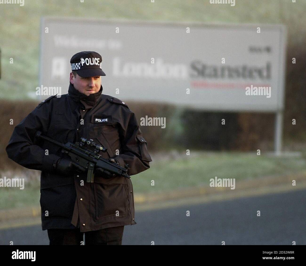 An armed policeman stands guard at the access road to Stansted Airport which has been closed to public traffic. Police shut the road which leads to the main entrance to the terminal of the Essex airport.   *  A spokesman said the measure was in connection with increased security at UK airports. Stock Photo