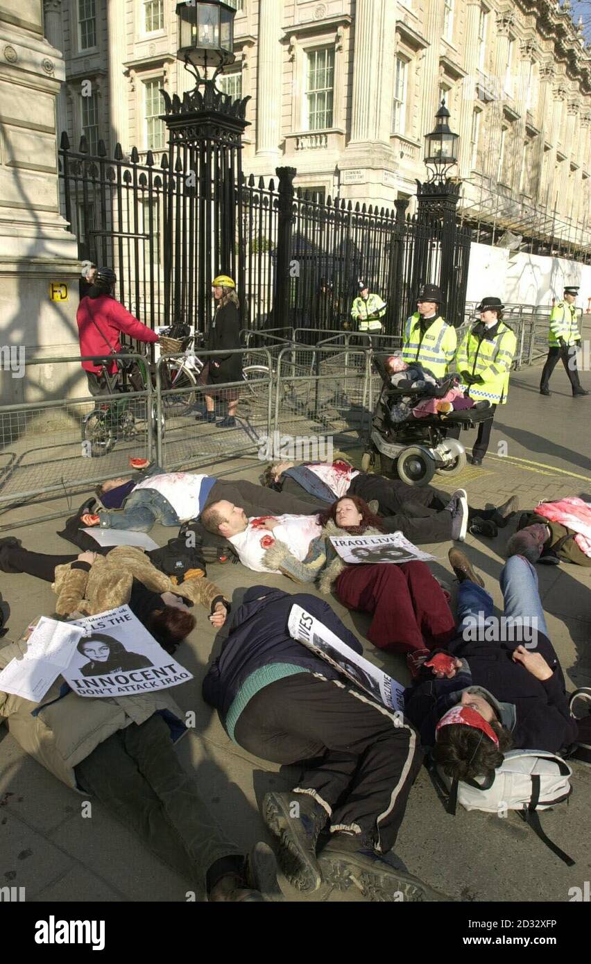 Anti-war activists stage a 'Die-in' protest against war on Iraq outside Downing Street in Whitehall, London. Stock Photo