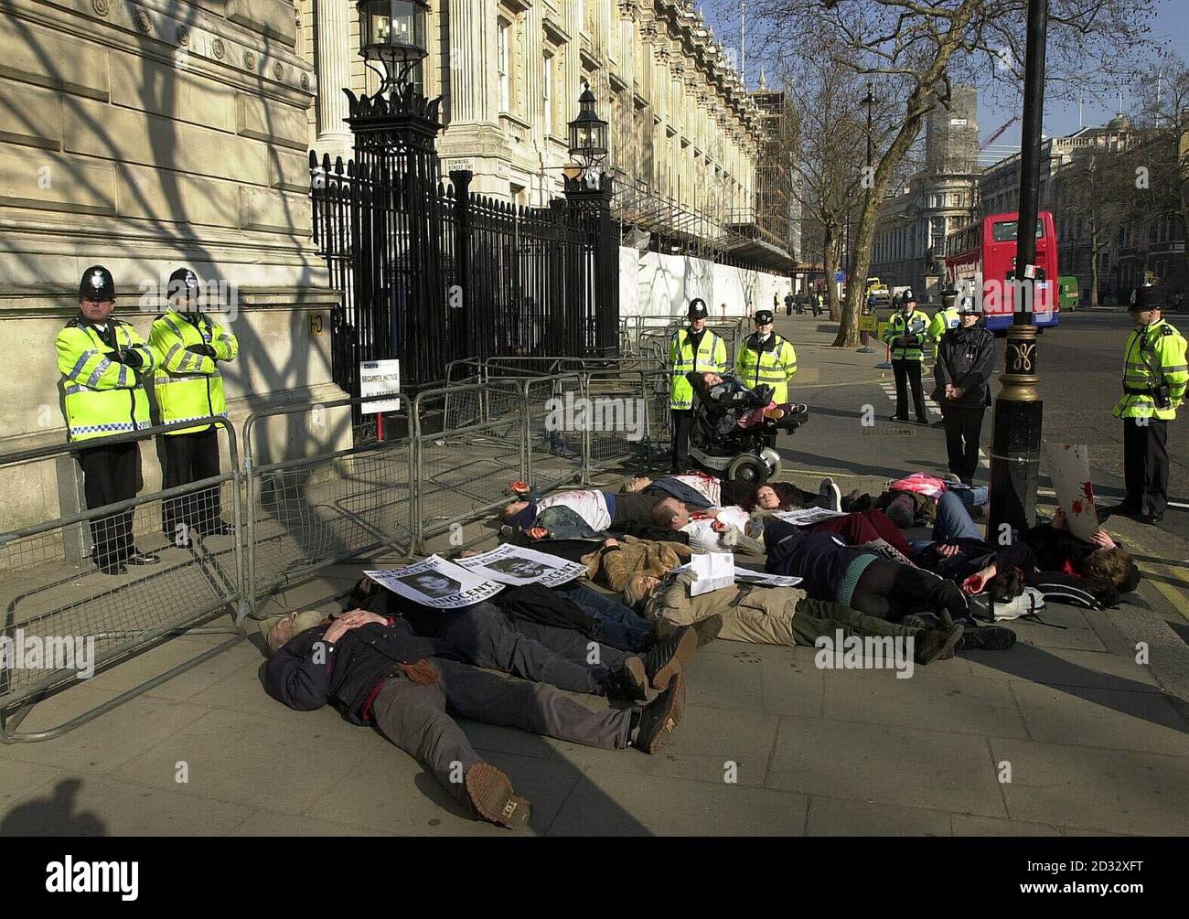 Anti-war activists stage a 'Die-in' protest against war on Iraq outside Downing Street in Whitehall, London. Stock Photo